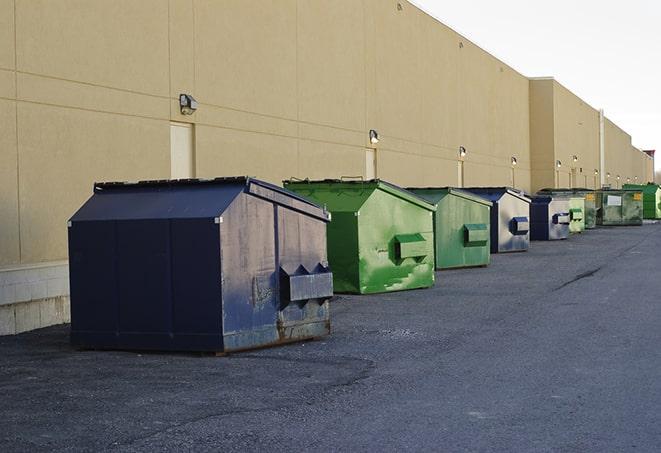 a fleet of red and blue construction dumpsters available for use in Canyon Lake, CA